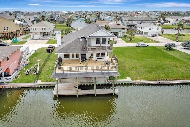 23002 Lunes St, Galveston, TX 77554 - rear view of house featuring a residential view, a balcony, a deck with water view, and a fenced backyard