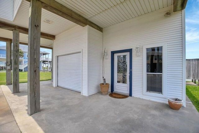 23002 Lunes St, Galveston, TX 77554 - entrance to property with a garage