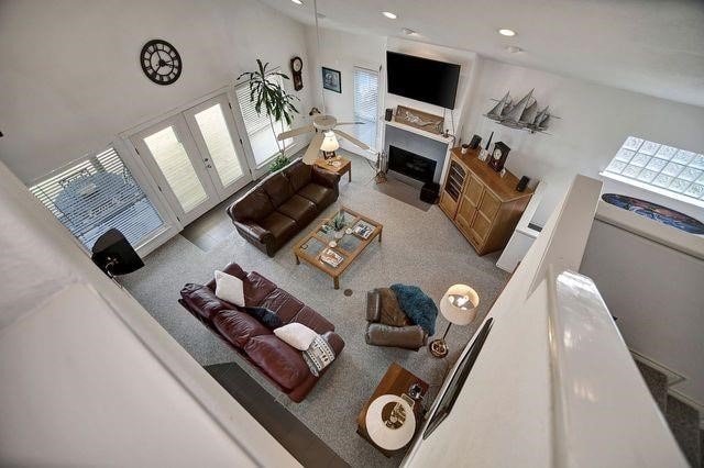23002 Lunes St, Galveston, TX 77554 - carpeted living room featuring a fireplace and recessed lighting