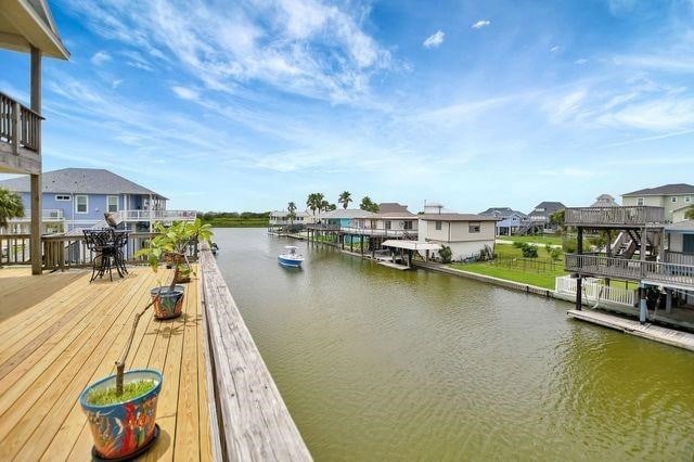 23002 Lunes St, Galveston, TX 77554 - dock area featuring a water view and a residential view