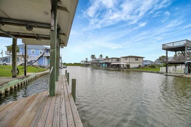 23002 Lunes St, Galveston, TX 77554 - dock area featuring a water view and a residential view