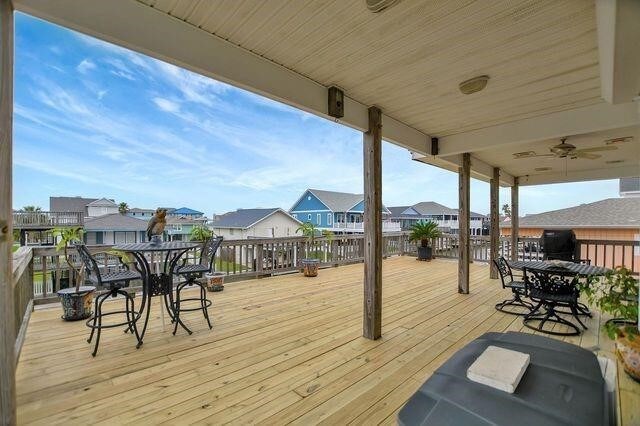 23002 Lunes St, Galveston, TX 77554 - wooden deck with a residential view and outdoor dining area