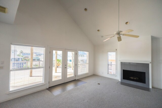23002 Lunes St, Galveston, TX 77554 - unfurnished living room with carpet flooring, high vaulted ceiling, french doors, a ceiling fan, and a fireplace