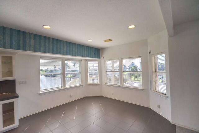 23002 Lunes St, Galveston, TX 77554 - unfurnished dining area featuring recessed lighting, wallpapered walls, and dark tile patterned flooring