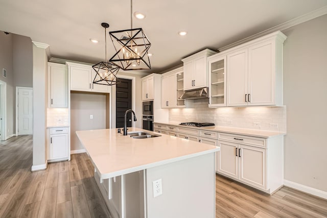 2008 Bristol Cliff Ln, Pearland, TX 77089 - kitchen with white cabinetry, a center island with sink, a chandelier, backsplash, and recessed lighting