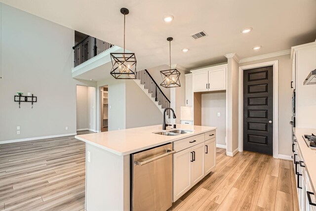 2008 Bristol Cliff Ln, Pearland, TX 77089 - kitchen with appliances with stainless steel finishes, light wood-type flooring, white cabinetry, light countertops, and pendant lighting