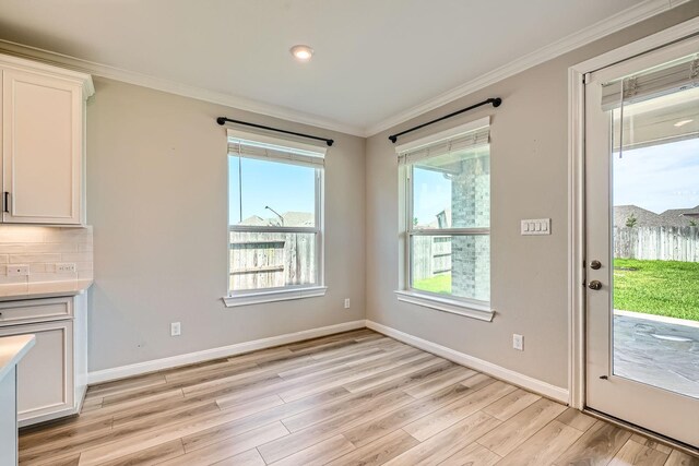 2008 Bristol Cliff Ln, Pearland, TX 77089 - unfurnished dining area featuring ornamental molding and light wood-type flooring