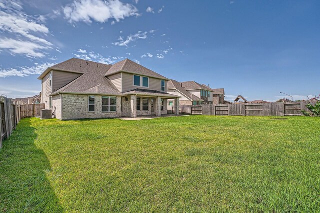 2008 Bristol Cliff Ln, Pearland, TX 77089 - rear view of property with brick siding, roof with shingles, a patio area, and a fenced backyard