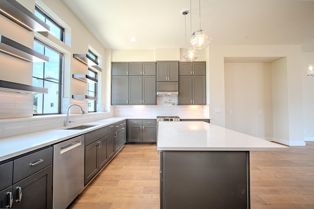 1716 Sedola Ln, Houston, TX 77055 - kitchen featuring dishwasher, a kitchen island, light wood-style flooring, healthy amount of natural light, and recessed lighting