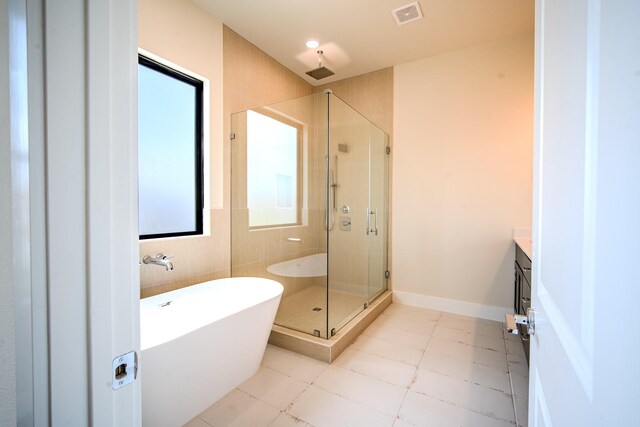 1716 Sedola Ln, Houston, TX 77055 - full bath featuring vanity, a soaking tub, a shower stall, and tile patterned floors