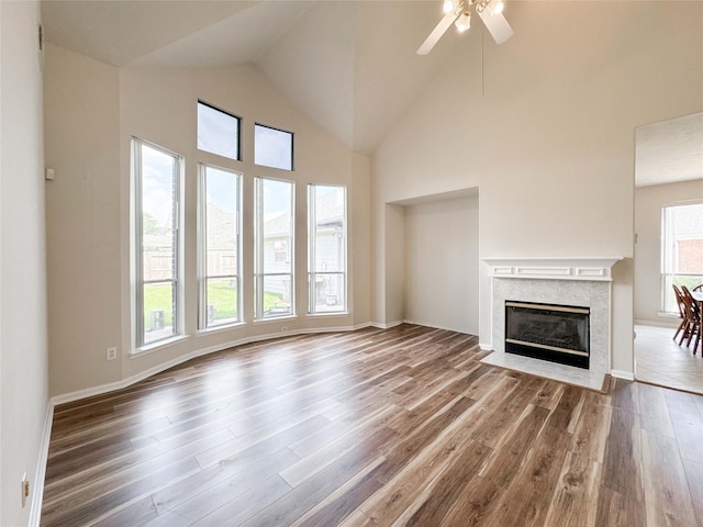 3106 Alexandros Ct, Pearland, TX 77584 - unfurnished living room featuring wood finished floors, a premium fireplace, ceiling fan, and high vaulted ceiling