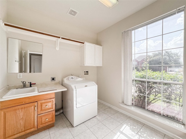 3106 Alexandros Ct, Pearland, TX 77584 - laundry room featuring washer / dryer, cabinet space, and light tile patterned floors
