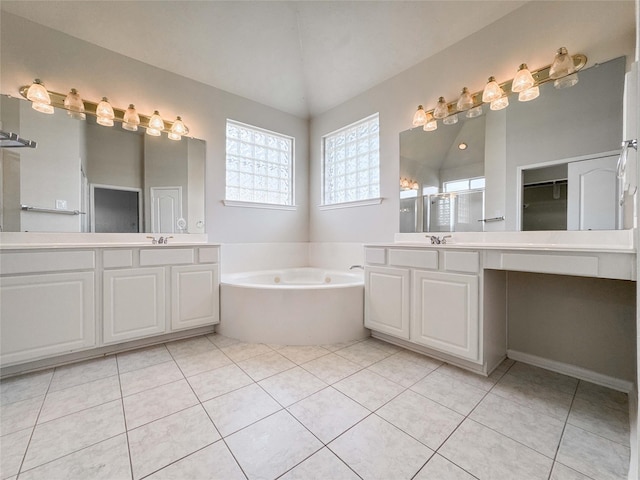 3106 Alexandros Ct, Pearland, TX 77584 - bathroom featuring a garden tub, two vanities, tile patterned floors, and lofted ceiling