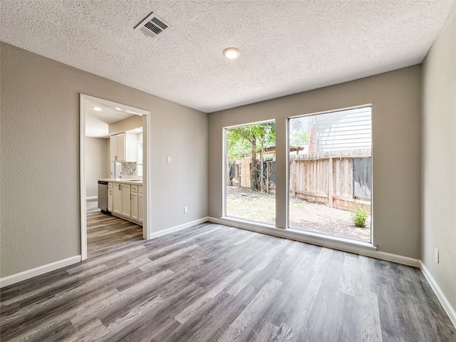 10610 Mills Prairie St, Houston, TX 77070 - spare room with wood finished floors and a textured ceiling