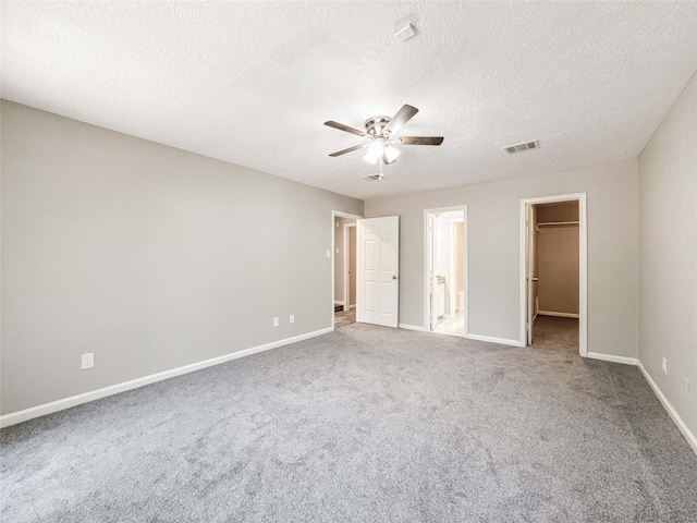 10610 Mills Prairie St, Houston, TX 77070 - unfurnished bedroom with a spacious closet, carpet floors, a textured ceiling, ceiling fan, and ensuite bathroom