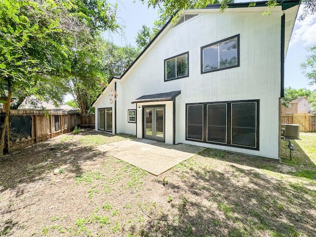 10610 Mills Prairie St, Houston, TX 77070 - back of property with french doors, a fenced backyard, and a patio area