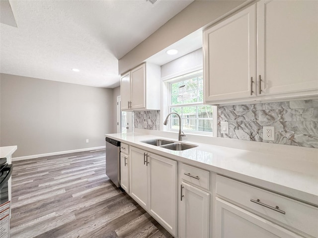 10610 Mills Prairie St, Houston, TX 77070 - kitchen featuring dishwasher, light wood-style flooring, white cabinets, light countertops, and recessed lighting