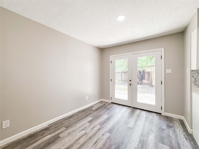10610 Mills Prairie St, Houston, TX 77070 - doorway to outside with french doors, wood finished floors, and a textured ceiling
