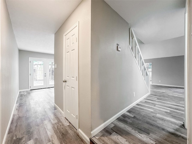 10610 Mills Prairie St, Houston, TX 77070 - hallway with wood finished floors, stairway, and french doors