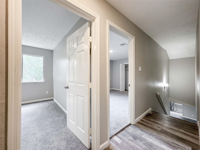10610 Mills Prairie St, Houston, TX 77070 - hall featuring an upstairs landing, a textured ceiling, and wood finished floors
