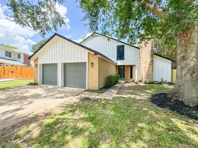 10610 Mills Prairie St, Houston, TX 77070 - view of front facade with a garage, driveway, board and batten siding, and brick siding