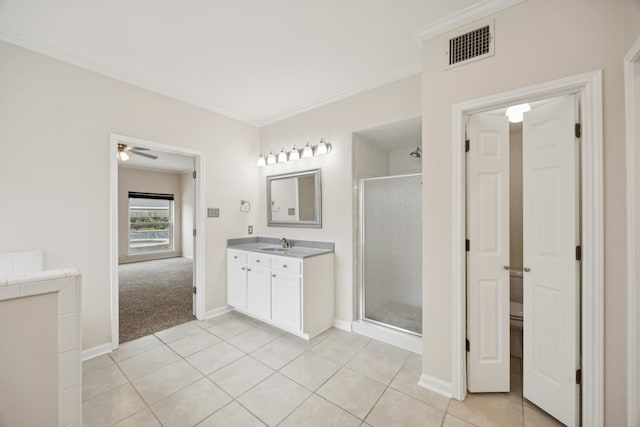 2537 La Rochelle Ct, Seabrook, TX 77586 - full bath featuring vanity, a stall shower, crown molding, tile patterned floors, and a ceiling fan