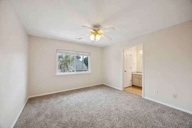 2537 La Rochelle Ct, Seabrook, TX 77586 - spare room featuring light colored carpet and a ceiling fan