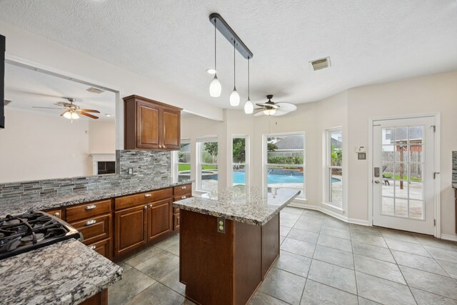 2537 La Rochelle Ct, Seabrook, TX 77586 - kitchen featuring ceiling fan, tasteful backsplash, and plenty of natural light