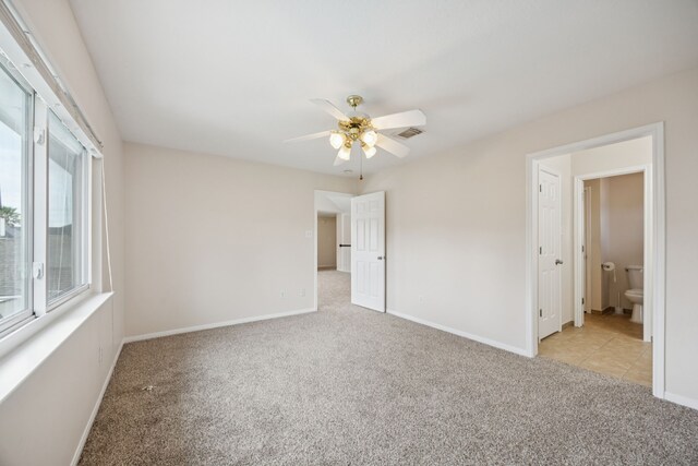 2537 La Rochelle Ct, Seabrook, TX 77586 - unfurnished bedroom with light colored carpet, multiple windows, and ceiling fan
