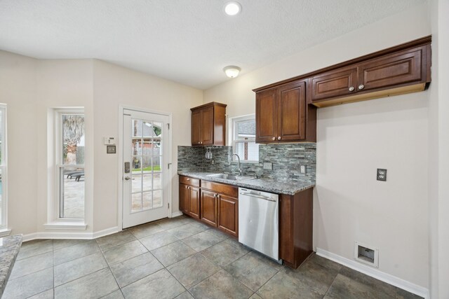 2537 La Rochelle Ct, Seabrook, TX 77586 - kitchen featuring stainless steel dishwasher, backsplash, and light stone countertops