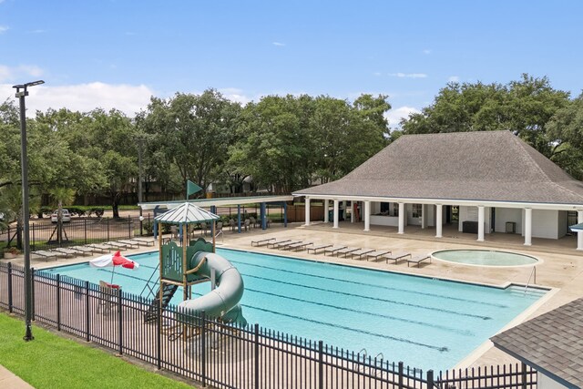 2537 La Rochelle Ct, Seabrook, TX 77586 - community pool with view of wooded area, a hot tub, and a patio area