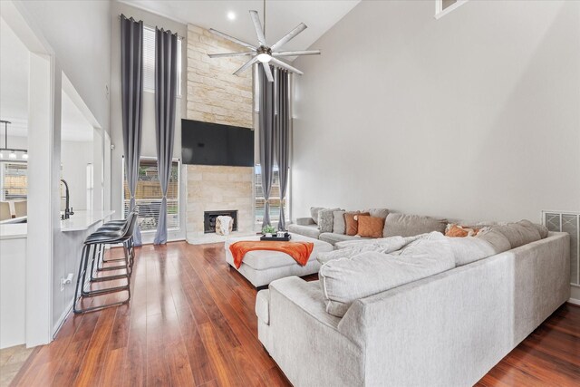 4318 Raintree Ct, Pasadena, TX 77505 - living room with hardwood / wood-style flooring, a ceiling fan, a fireplace, and high vaulted ceiling