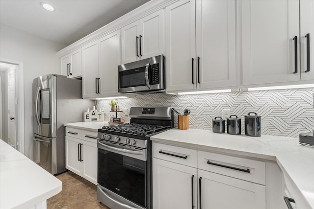 4318 Raintree Ct, Pasadena, TX 77505 - kitchen featuring stainless steel appliances, backsplash, white cabinets, light stone countertops, and recessed lighting