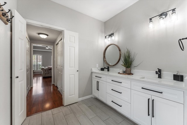 4318 Raintree Ct, Pasadena, TX 77505 - bathroom featuring double vanity and wood finished floors