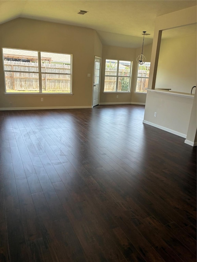 19638 Plantation Grove Trl, Katy, TX 77449 - unfurnished living room featuring dark wood finished floors, a chandelier, and vaulted ceiling