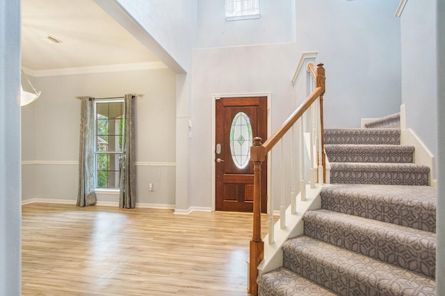 8806 Aberdeen Oaks Dr, Houston, TX 77095 - foyer featuring wood finished floors, stairs, ornamental molding, and a high ceiling