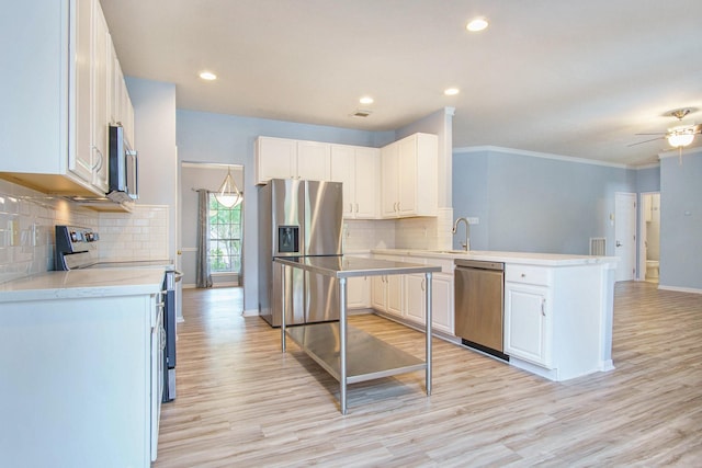 8806 Aberdeen Oaks Dr, Houston, TX 77095 - kitchen featuring appliances with stainless steel finishes, a peninsula, light countertops, light wood-style floors, and tasteful backsplash