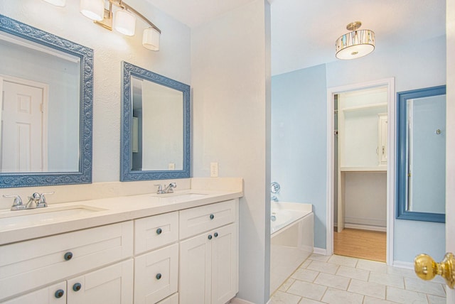 8806 Aberdeen Oaks Dr, Houston, TX 77095 - full bath featuring double vanity, a bath, and tile patterned flooring