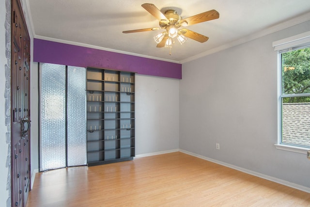 8806 Aberdeen Oaks Dr, Houston, TX 77095 - empty room featuring wood finished floors, a ceiling fan, and ornamental molding