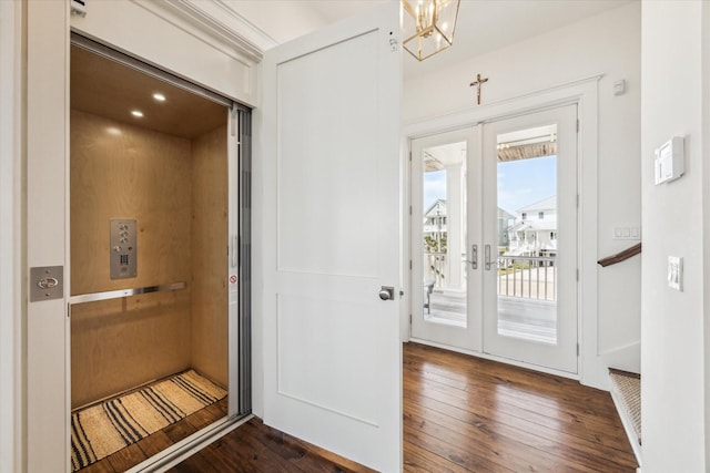 4107 Bluewing Teal Ct, Galveston, TX 77554 - doorway with french doors, dark wood-style flooring, elevator, and a chandelier