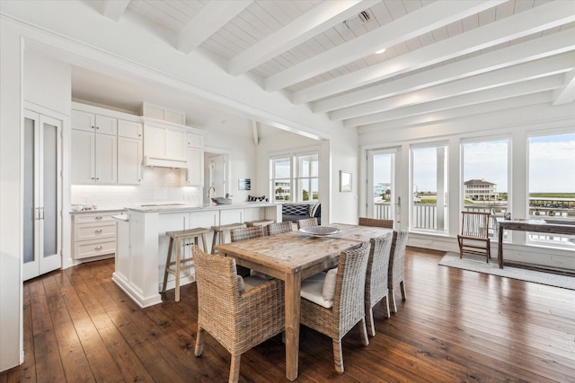 4107 Bluewing Teal Ct, Galveston, TX 77554 - dining space featuring beam ceiling and dark wood-type flooring