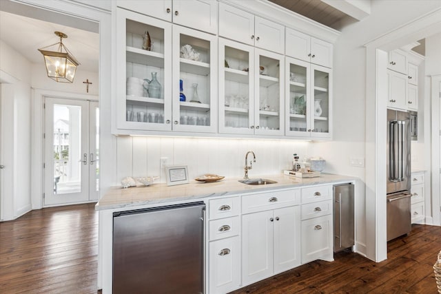 4107 Bluewing Teal Ct, Galveston, TX 77554 - bar area featuring refrigerator, high quality fridge, dark wood finished floors, and beverage cooler