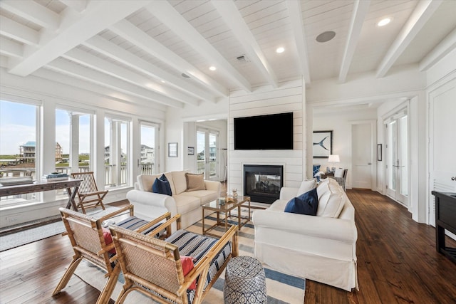 4107 Bluewing Teal Ct, Galveston, TX 77554 - living area with a fireplace, beamed ceiling, dark wood-style floors, and recessed lighting