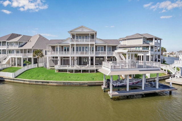 4107 Bluewing Teal Ct, Galveston, TX 77554 - rear view of property with a water view, a balcony, stairs, a lawn, and boat lift