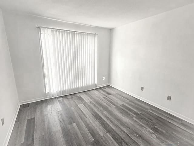 2824 S Bartell Dr, Houston, TX 77054 - unfurnished room with dark wood-type flooring and baseboards