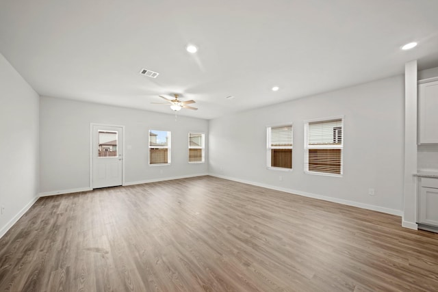 319 Bennett St, Angleton, TX 77515 - unfurnished living room featuring ceiling fan, wood finished floors, and recessed lighting