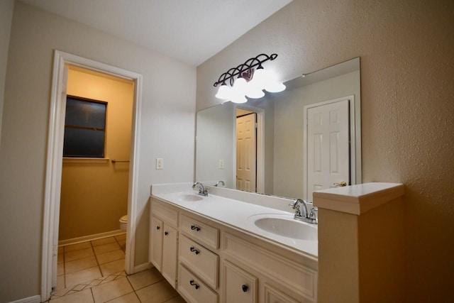18723 Clover Gln, Katy, TX 77084 - bathroom featuring double vanity, tile patterned floors, and a textured wall