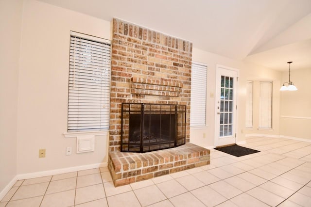 18723 Clover Gln, Katy, TX 77084 - unfurnished living room featuring tile patterned flooring, a brick fireplace, vaulted ceiling, and a chandelier