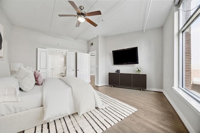 1901 Post Oak Blvd Unit 609, Houston, TX 77056 - bedroom with light wood-style floors, ensuite bathroom, and a ceiling fan