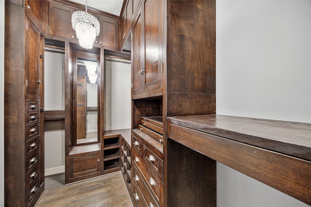 1901 Post Oak Blvd Unit 609, Houston, TX 77056 - spacious closet featuring dark wood-style flooring and a chandelier